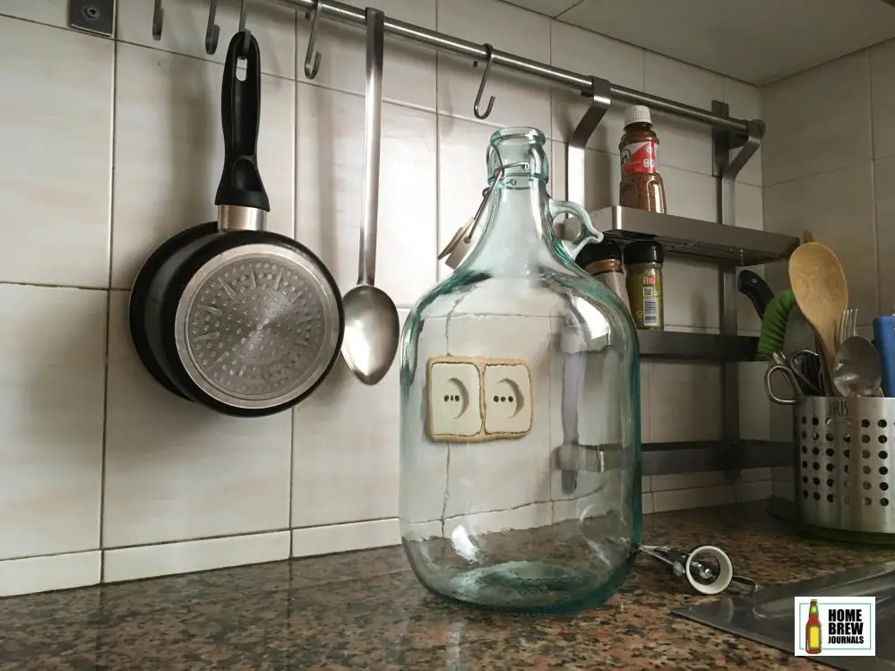 A five litre glass demijohn fermenting jar on the worksurface in my kitchen