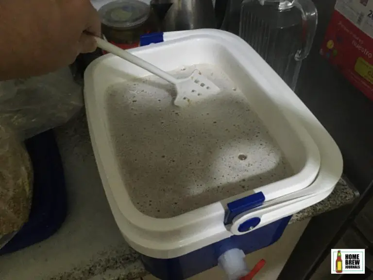 Mixing the mash in a small converted picnic cooler